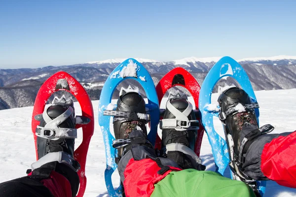 Caminhadas de inverno nas montanhas em sapatos de neve com uma mochila e tenda . — Fotografia de Stock