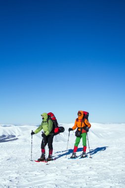 Dağlarda kar ayakkabıları bir sırt çantası ve çadır hiking kış.