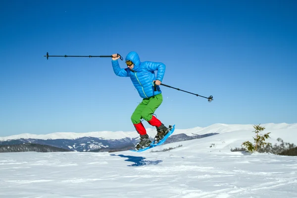 Winter hiking in the mountains on snowshoes with a backpack and tent. — Stock Photo, Image