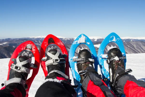 Caminhadas de inverno nas montanhas em sapatos de neve com uma mochila e tenda . — Fotografia de Stock