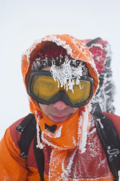 Winter hiking in the mountains on snowshoes with a backpack and tent. Stock Picture