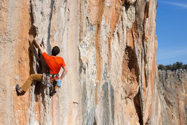 Joven escalador colgado por un acantilado. —  Fotos de Stock