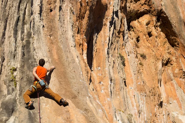 Giovane arrampicatore maschio appeso a una scogliera. — Foto Stock