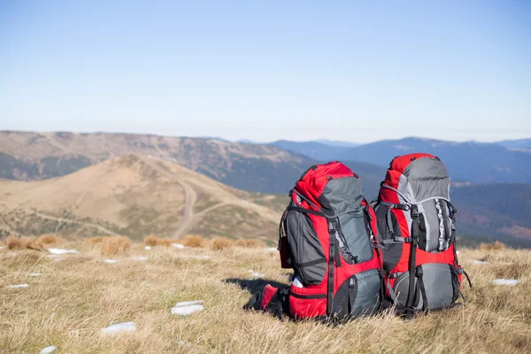 Roter Rucksack auf dem Gipfel des Berges. — Stockfoto