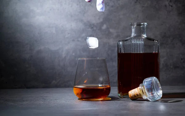 Quadratische Whiskeyflasche Und Glas Mit Eis Auf Dunkelgrauem Zementhintergrund — Stockfoto