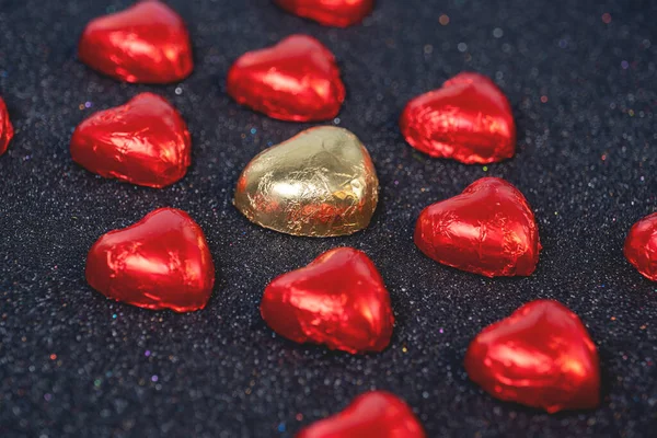 Heart Shaped Chocolates Red Foil Black Background Sparkles Royalty Free Stock Images