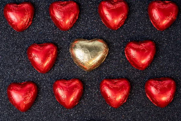 Heart Shaped Chocolates Red Foil Black Background Sparkles Royalty Free Stock Images