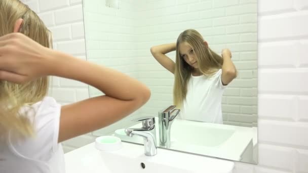 Дитяче волосся у дзеркалі, дитяче волосся у ванній кімнаті, білявка у рукоятці, зачіска. — стокове відео