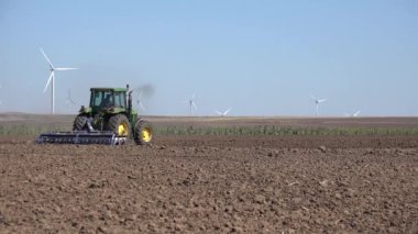 Farmer Working Agriculture Field, Tractor Plowing Land, Farming in Spring, Rustic View at Countryside