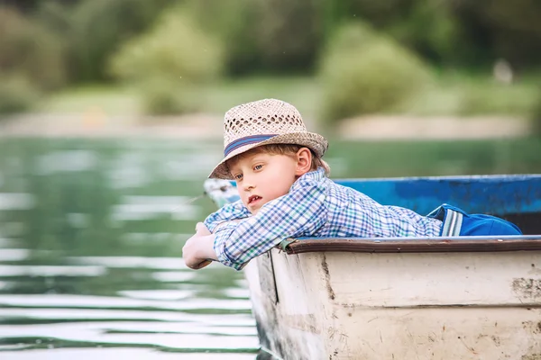 Dreaming boy in old boat — Stock Photo, Image