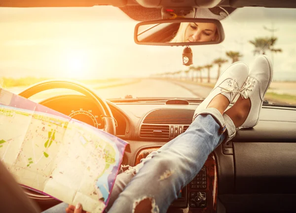 Woman in car with map — Stock Photo, Image