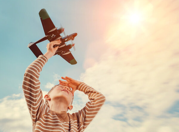 Boy playing with toy plane 