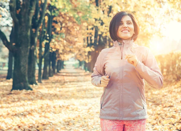 Rennende vrouw in park — Stockfoto