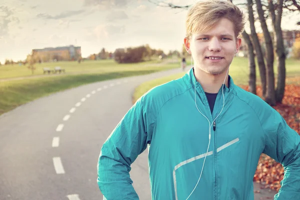 Young runner portrait in autumn park — Stock Photo, Image