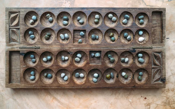 Antique Boa Mancala tradition African Board Game. Vintage Bao carved wooden Board Game. With natural baobab tree seeds Balls.