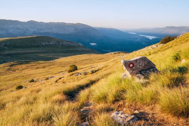 Hiking trail mark painted on rock. Landscape view from Sinjal or Dinara (1831 m) mountain -the highest point of Croatia in the Dinaric Alps on the border between the Croatia and Bosnia and Herzegovina clipart