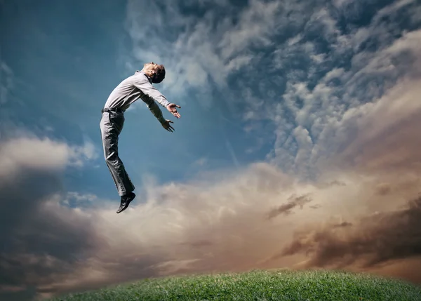 Jumping man in sky — Stock Photo, Image