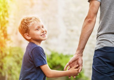 Son hold his father for hand clipart
