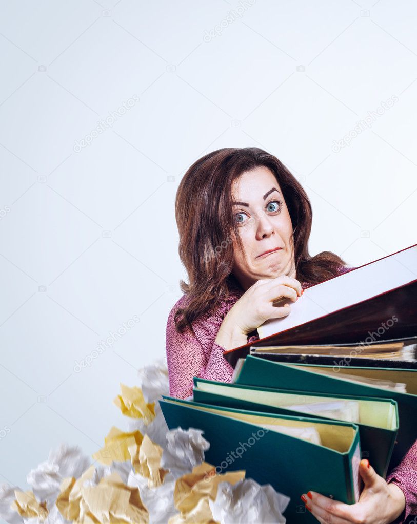 Mad faced businesswoman with folders