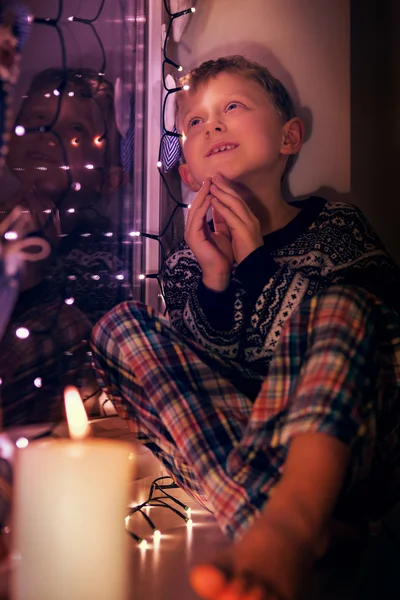 Boy dreaming about Christmass gifts Stock Photo