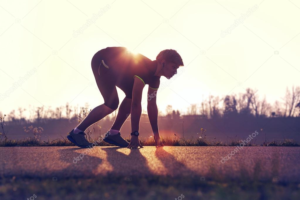 Athletic man starting  jogging