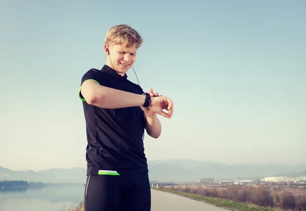 Runner starts his stopwatch — Stock Photo, Image