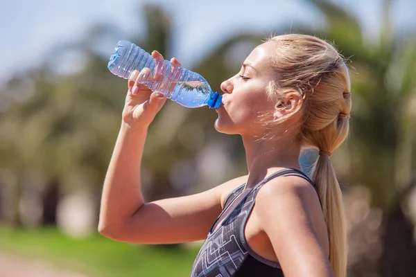 Girl drink  water after jogging