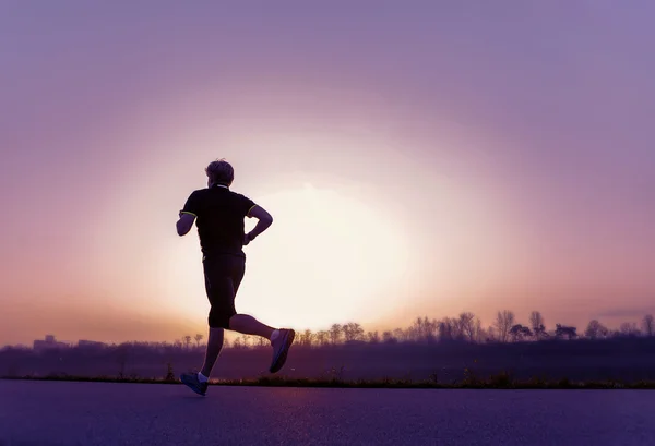 Running man  in sunset time — Stock Photo, Image