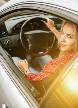 Arabada oturan genç bir kadın.