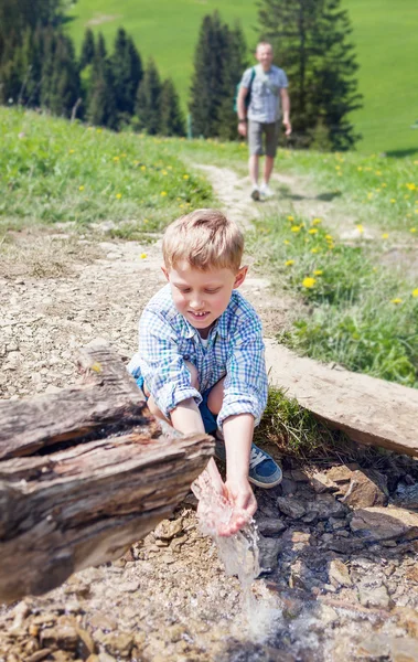 Chlapec v blízkosti horského potoka — Stock fotografie