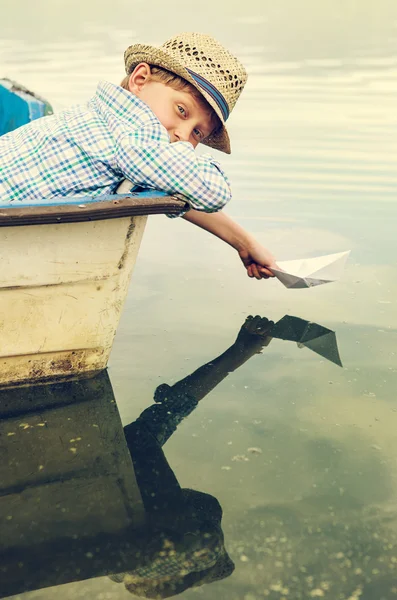 Boy launching paper ship — Stock Photo, Image