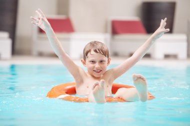 Happy boy swiming in pool clipart
