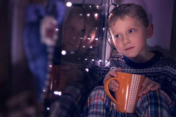 Niño junto a la ventana con la taza — Foto de Stock