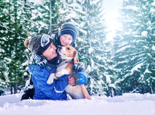 Mother with son and dog  in snow forest — Stock Photo, Image