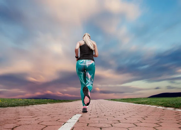 Young blonde girl evening jogging — Stock Photo, Image