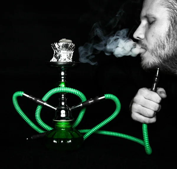 Man smokes a hookah — Stock Photo, Image