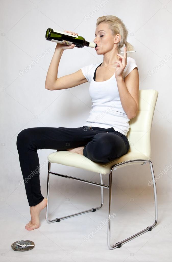 Woman with bottle of wine and cigarette