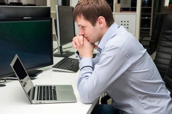 Young handsome man with computer in the office — Stock Photo, Image