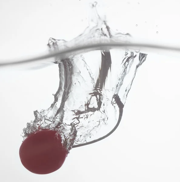 Cherry dropped into water — Stock Photo, Image