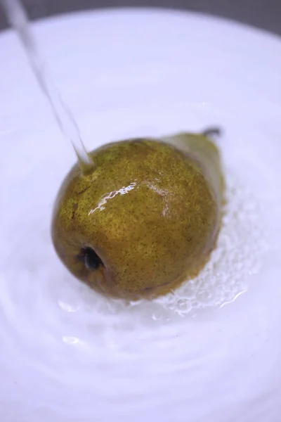 Yellow tasty pear under water