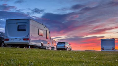 Caravans and cars  sunset clipart