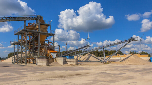 Sand sorting machine under blue clouded sky