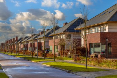 Detached family houses in a quiet street clipart