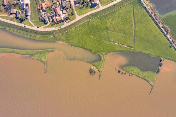 Flooded river landscape with submerged floodplains along river Lek in March near  the village of Ravenswaaij, Gelderland, Netherlands