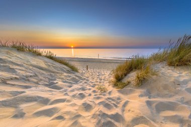 Hollanda 'nın Zeeland Eyaleti' ndeki Ouddorp 'ta, Kuzey Denizi ve Kanal üzerindeki kum tepelerinden Sunset View' ı davet ediyoruz. Avrupa 'nın doğasında sahilin açık hava sahnesi.
