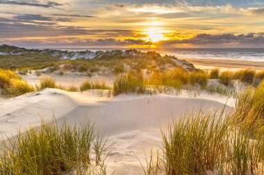 Sunset View from dune top over North Sea from the island of Ameland, Friesland, Netherlands clipart