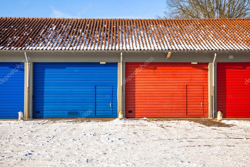 blue and red Garage Doors in Snow