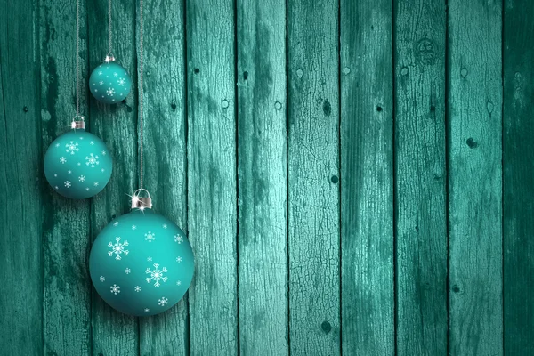 Turquoise blue xmas bulbs on wooden background
