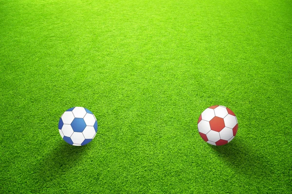 Artificial green grass with blue and red balls — Stock Photo, Image