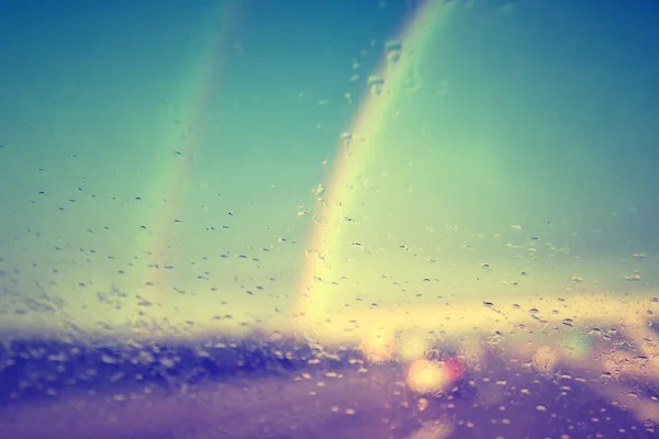 Vintage rainy windshield with rainbows